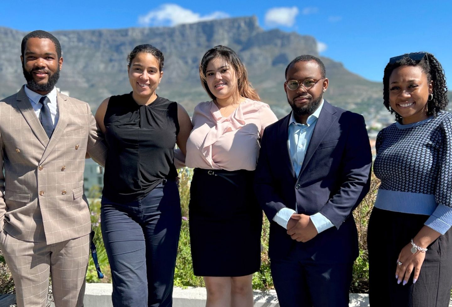 Attorney Luthando Dlamini and students Marley Peters, Aviae Gibson, Daniel Dunn and Laura-Louise Rice stand in front of Table Mountain