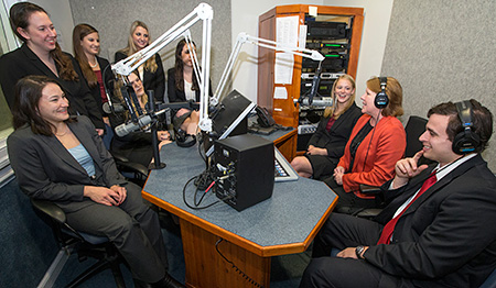 Innocence Project Clinic at UVA Law students and Deirdre Enright, second from right, gather in the studio where an interview for the 