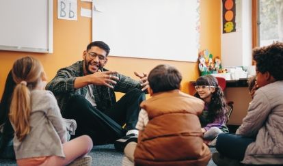Children and a teacher sit in class